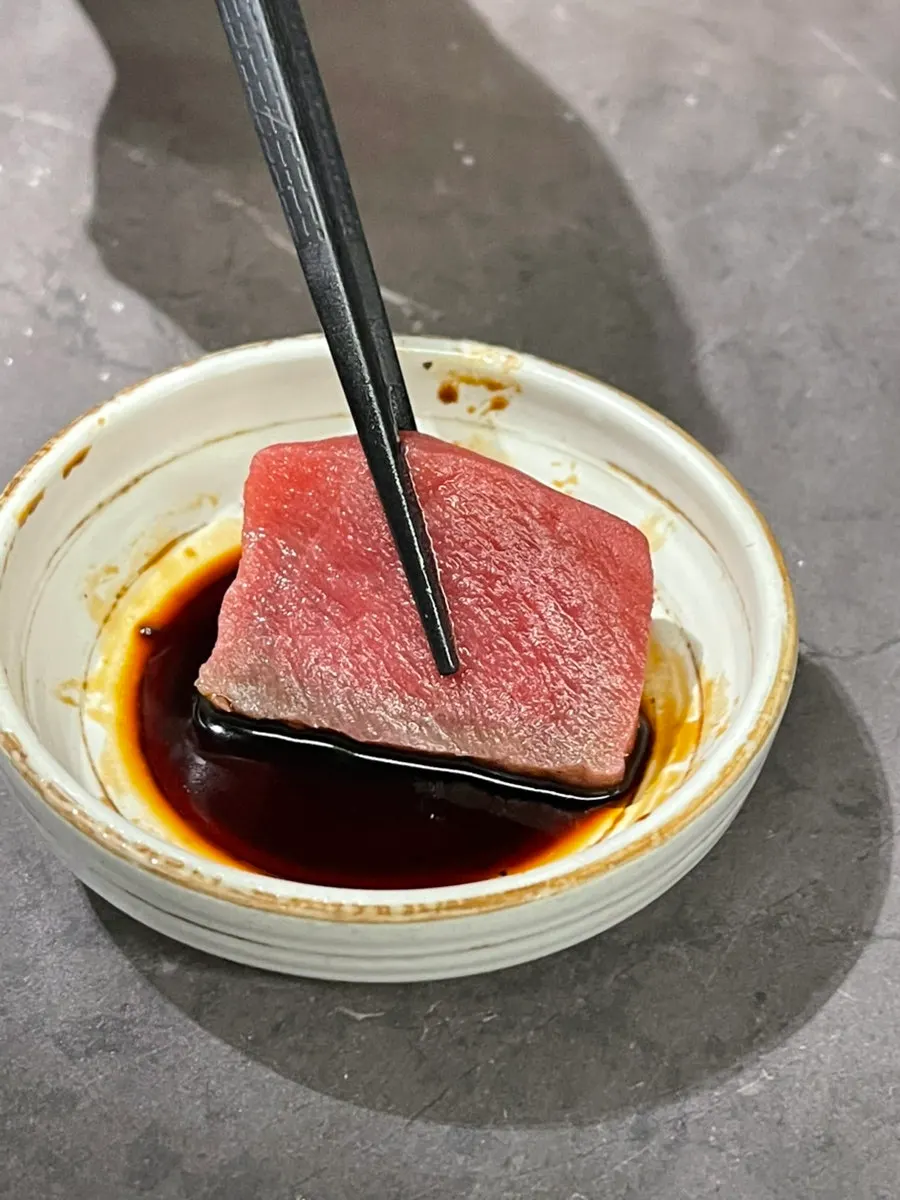 A single piece of aged white fish sashimi