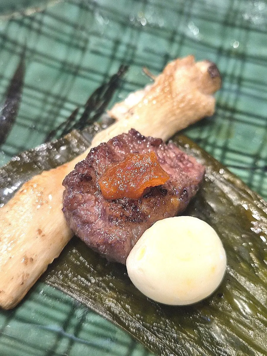 Wrap of black pork, mushrooms, and garlic in myeongi-namul