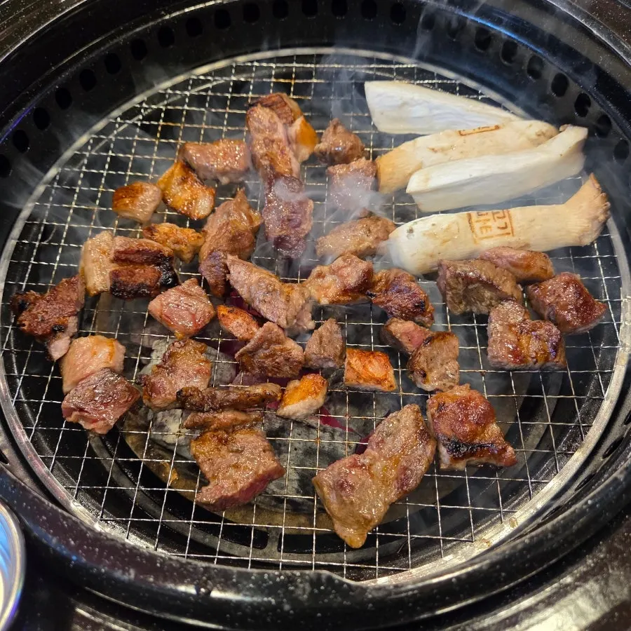 Pork neck cooking on the grill