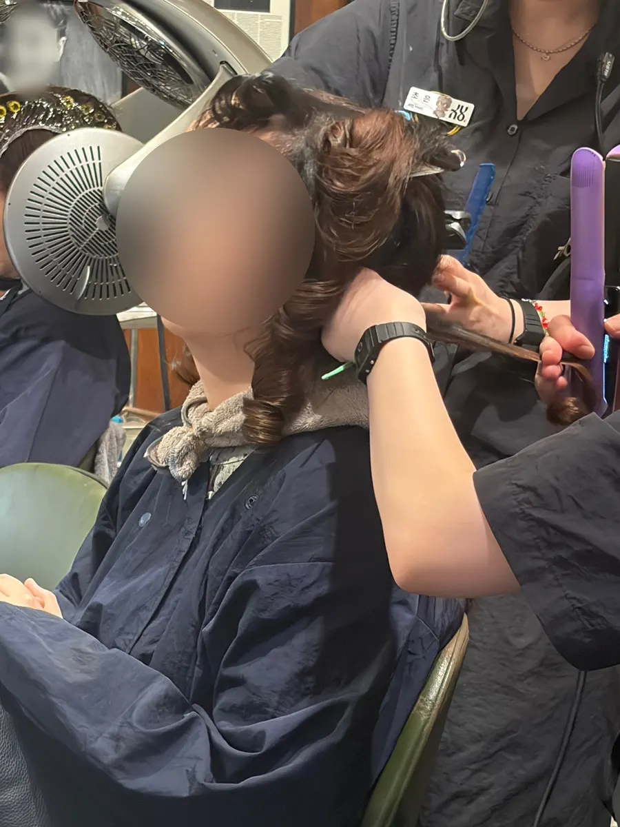 Straightening the hair with a flat iron during the treatment