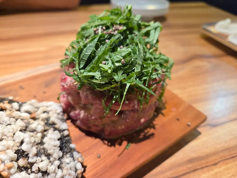 Close-up of beef tartare mixed with seasoning
