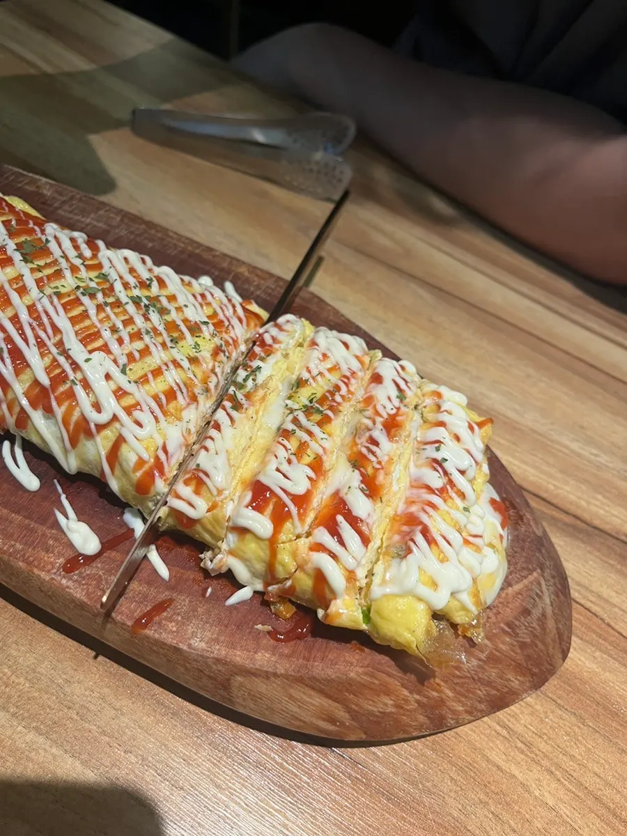 Large half-and-half king egg roll served at the table