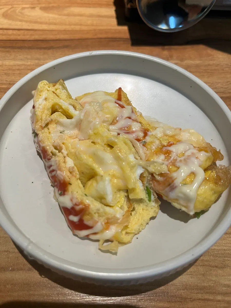 Cross-section of the king egg roll showing cheese and stir-fried kimchi halves