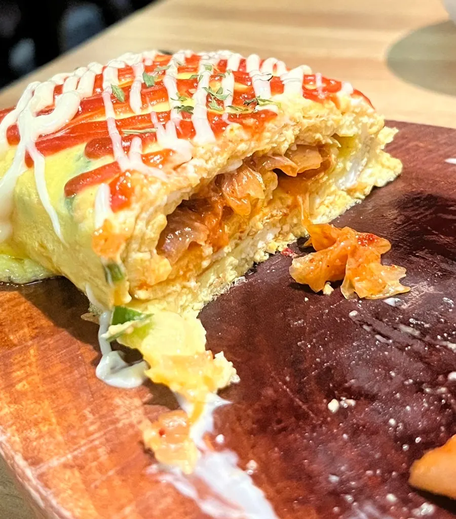 A piece of egg roll from the cheese-filled side