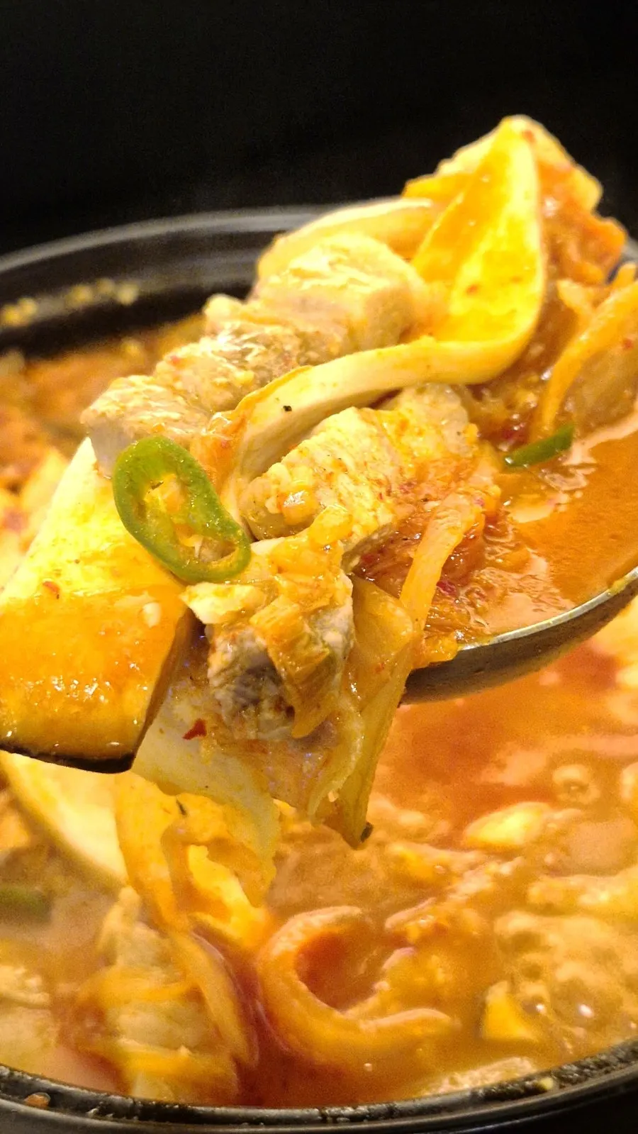 Close-up of pork belly kimchi jjigae bubbling