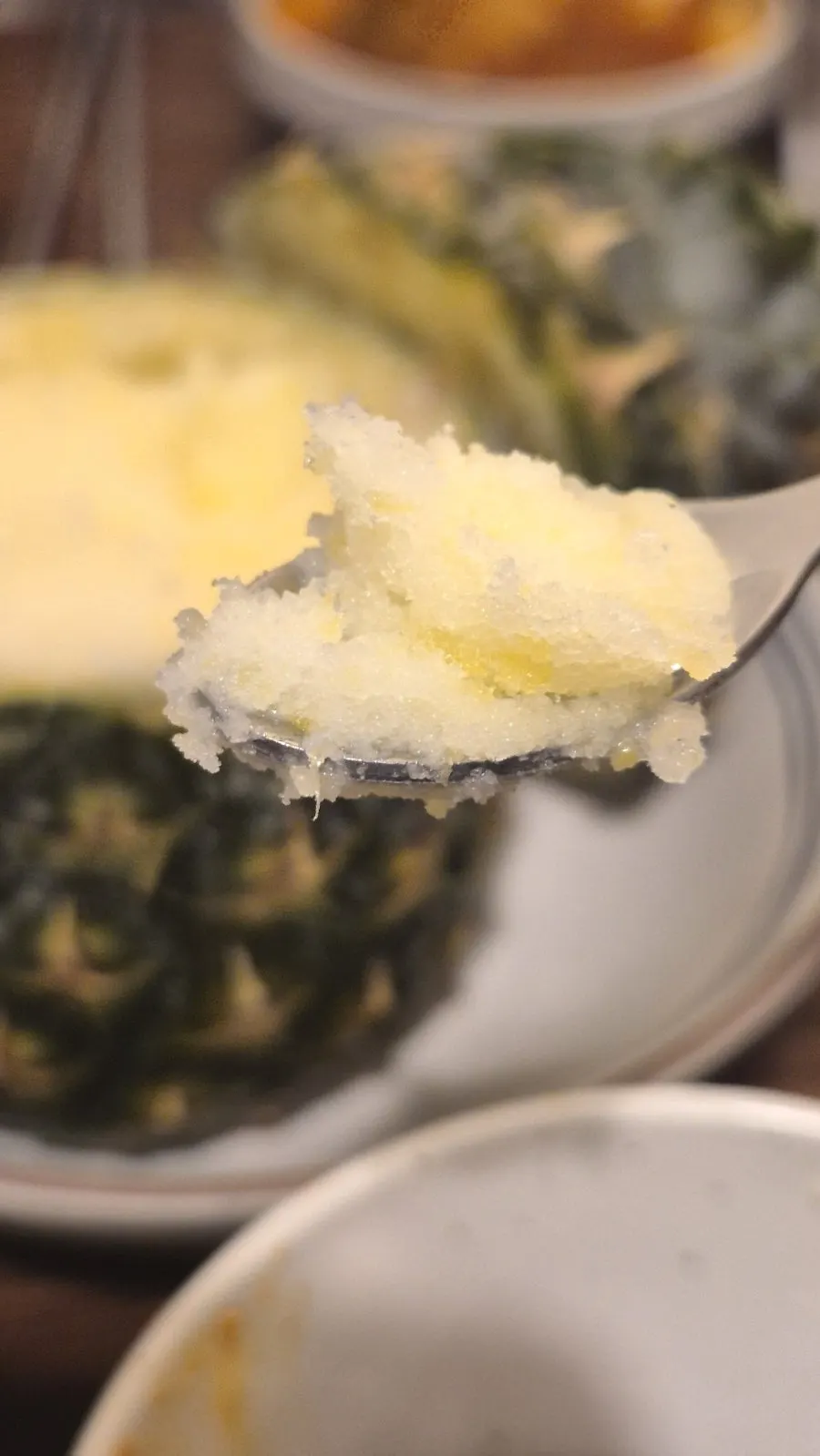 A spoonful of pineapple sherbet full of icy slush