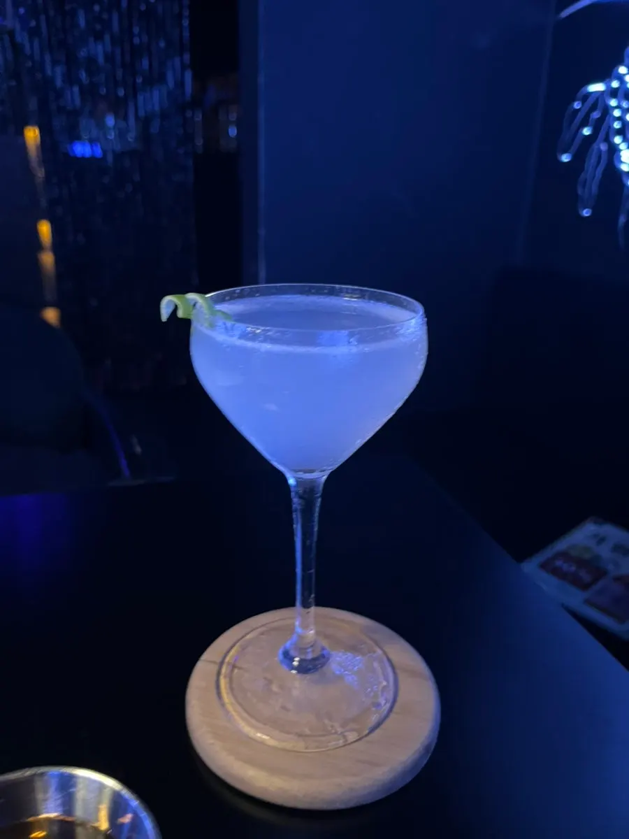 Fresh gin cocktail topped with cucumber