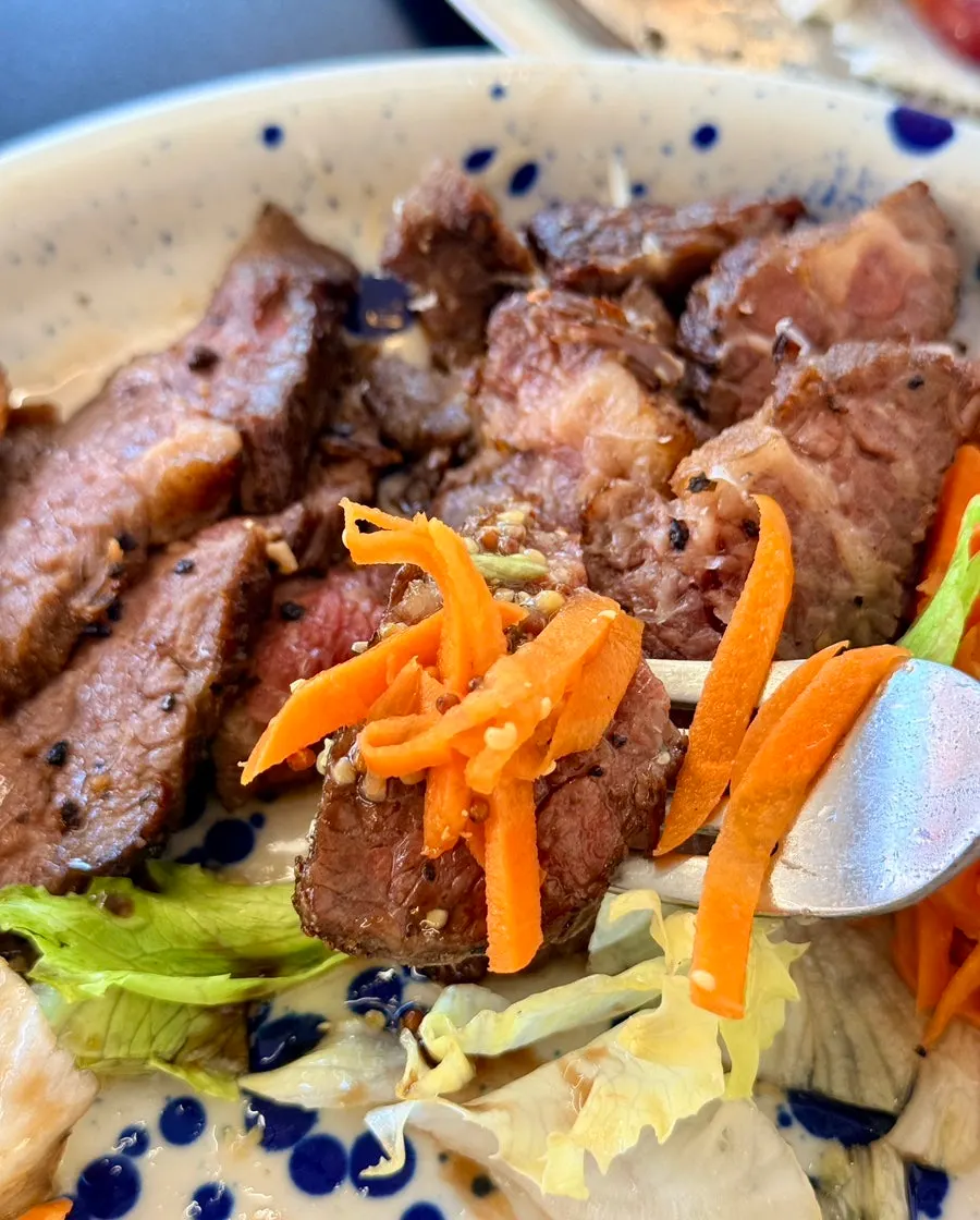 Steak served with carrot rapée and salad
