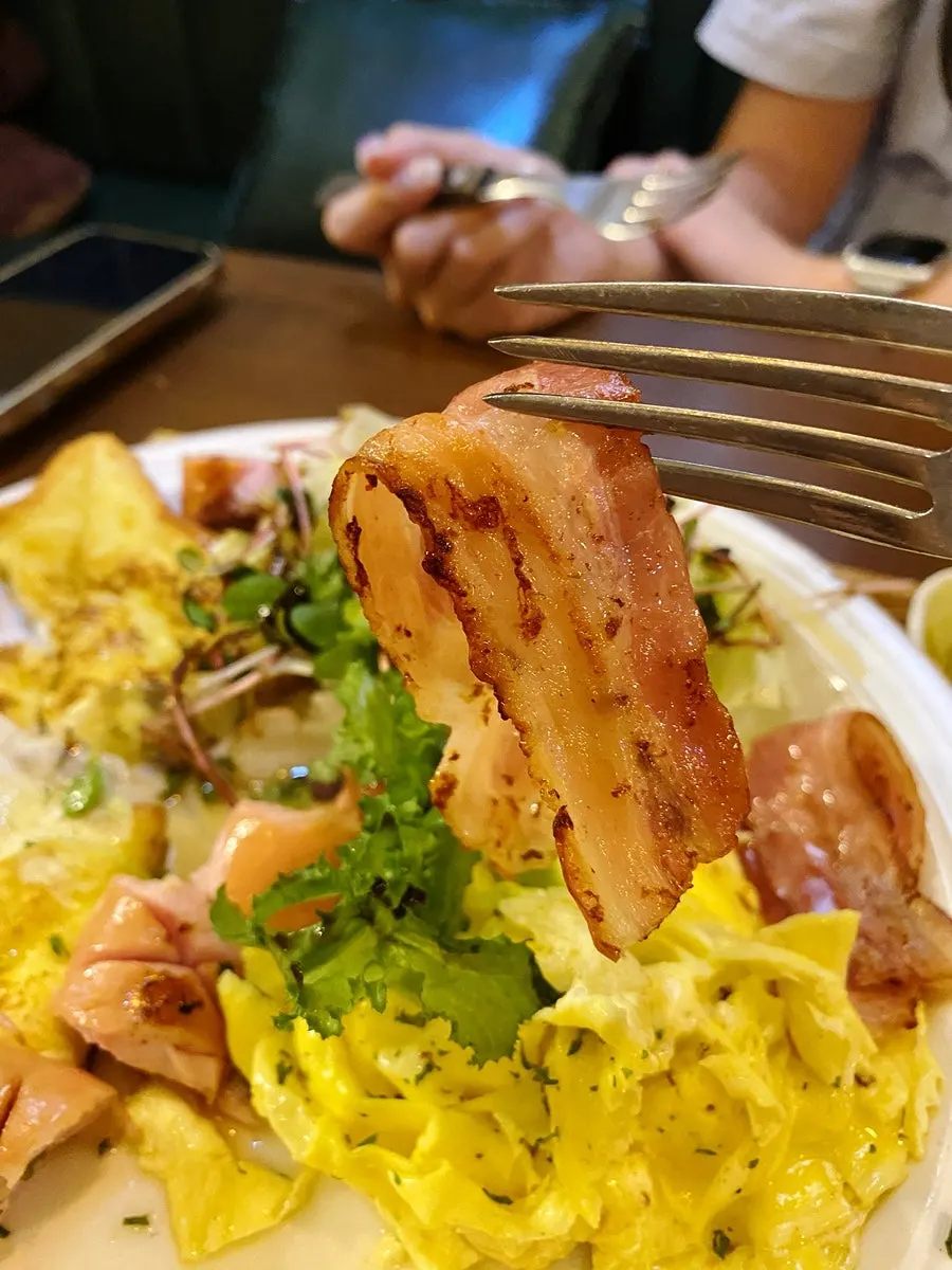 French toast plate with scrambled eggs and bacon