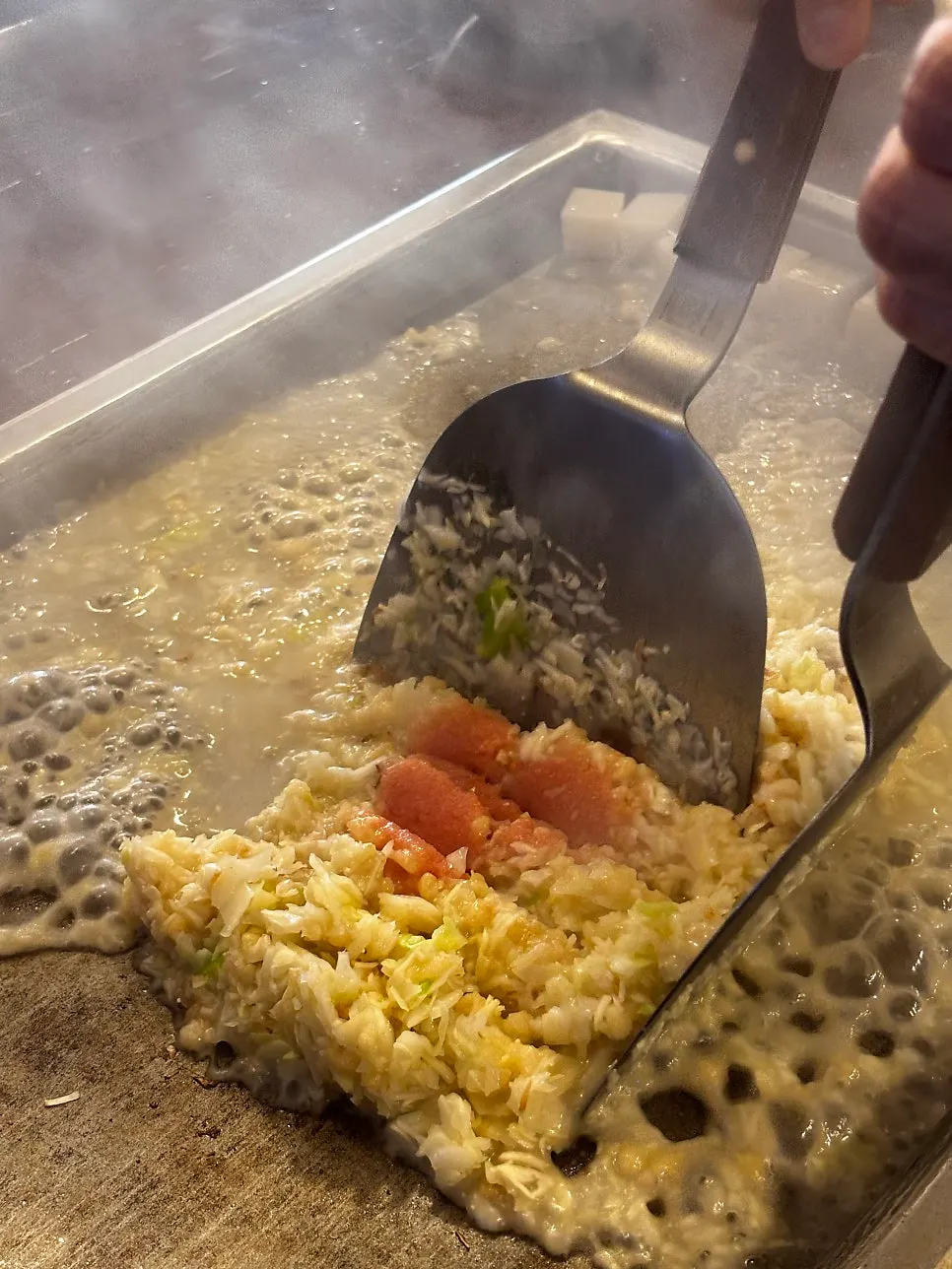 Monjayaki batter spread wide on the teppan