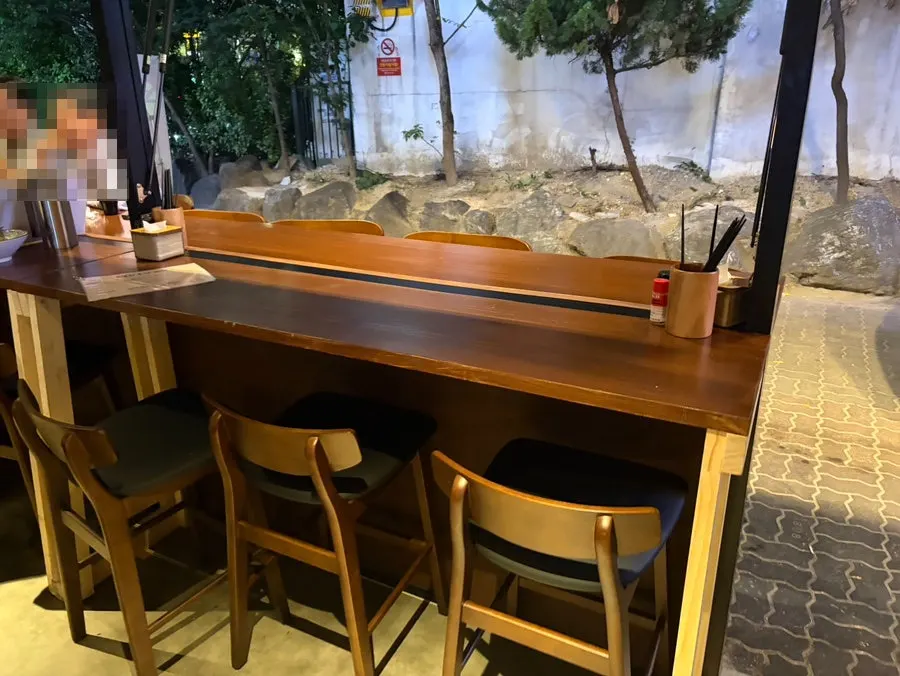 Outdoor seating under Kaken's silver tin roof