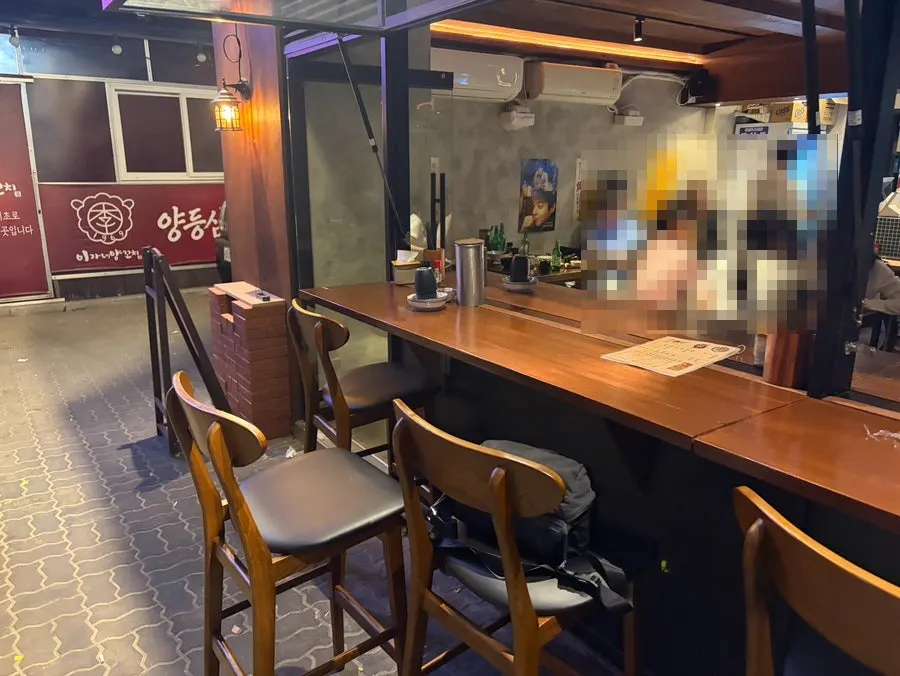 Indoor seating and kitchen view at Kaken