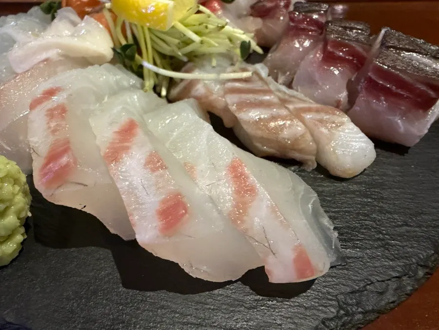 Sashimi platter with daikon sprouts and lemon