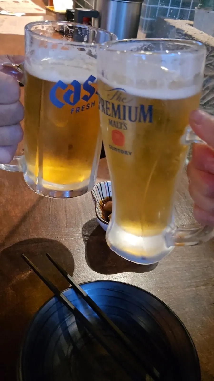 Raising a draft beer glass for a toast