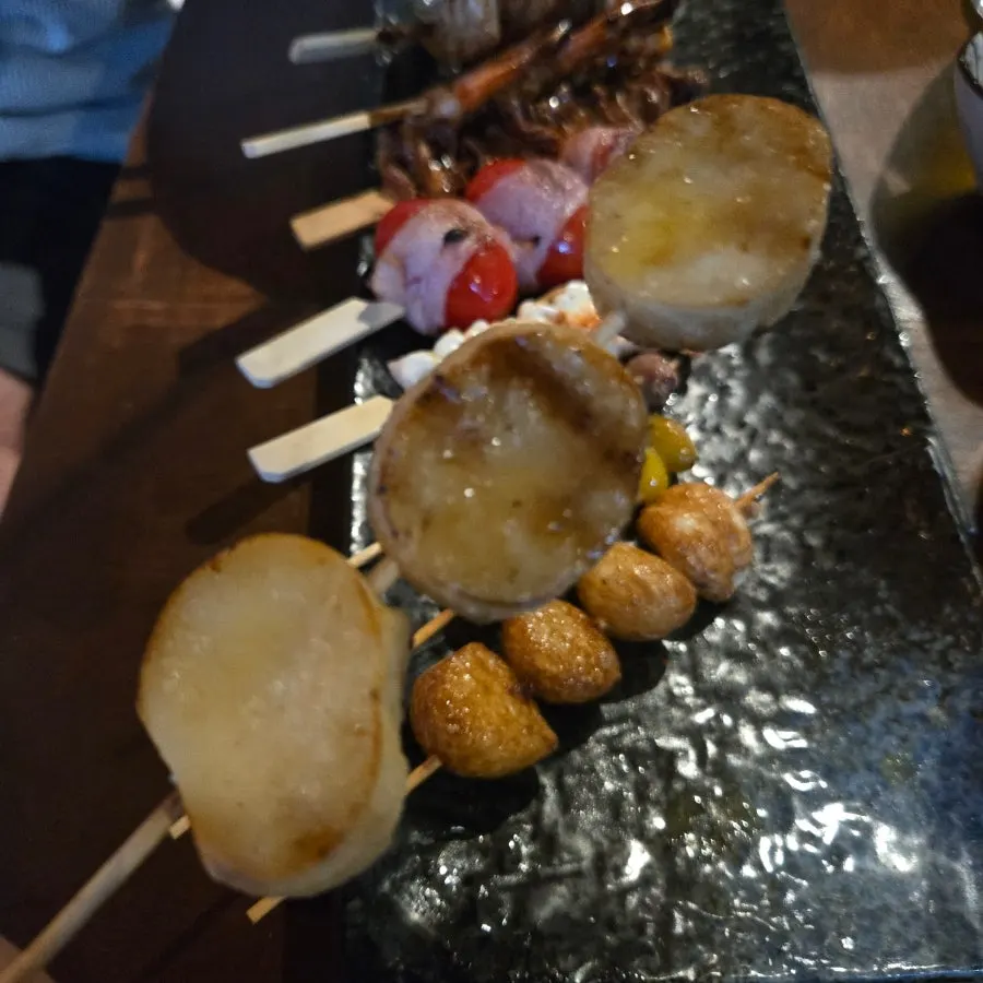 Skewers grilling over charcoal