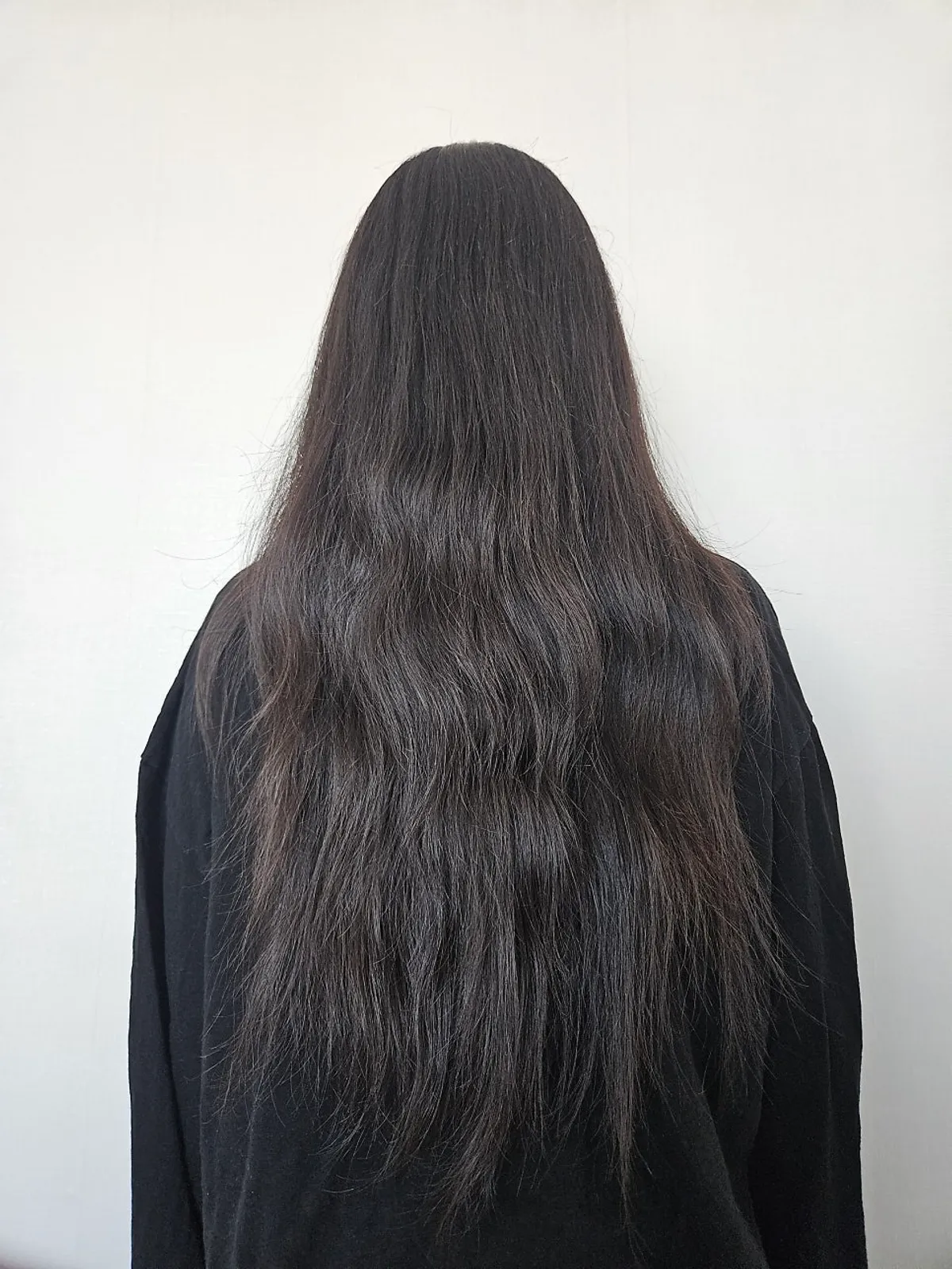 Before photo showing curls and leftover wave perm before straightening