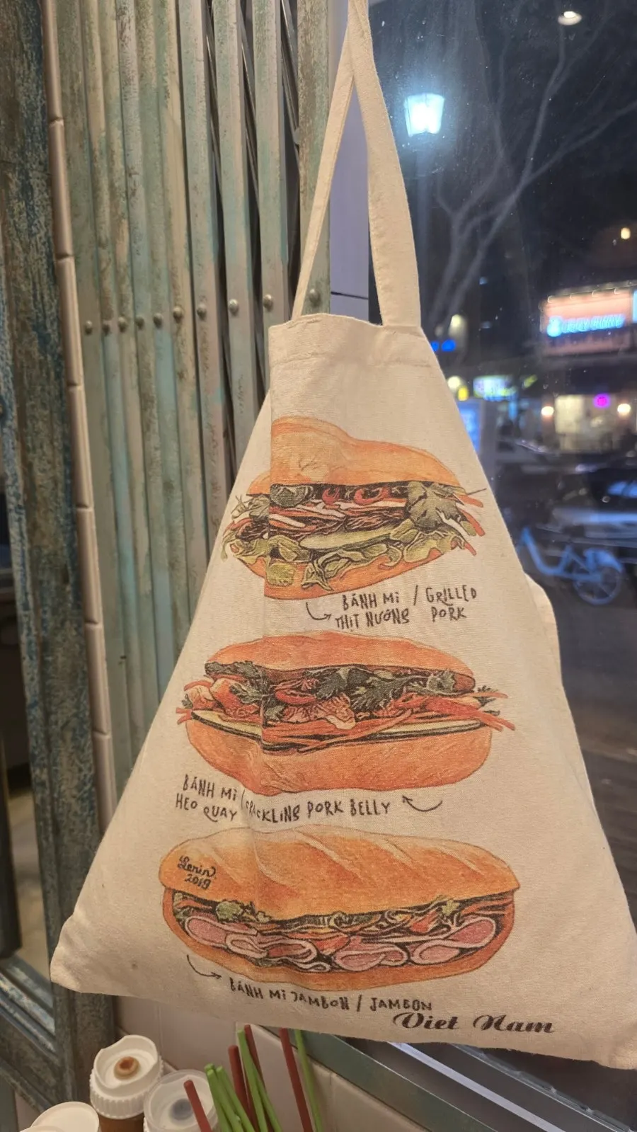 Wall sign at Kkamon noting banh mi sales and takeout availability