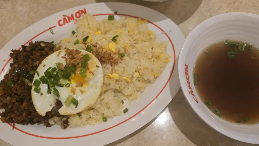 Kkamon fried rice topped with a soft fried egg