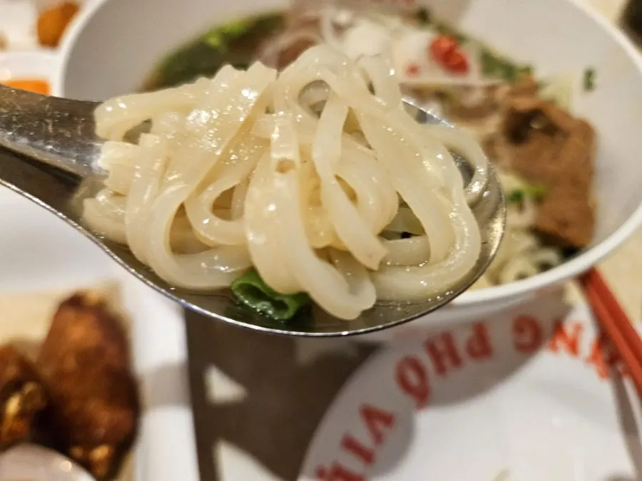 Noodles and pork backbone lifted together with chopsticks