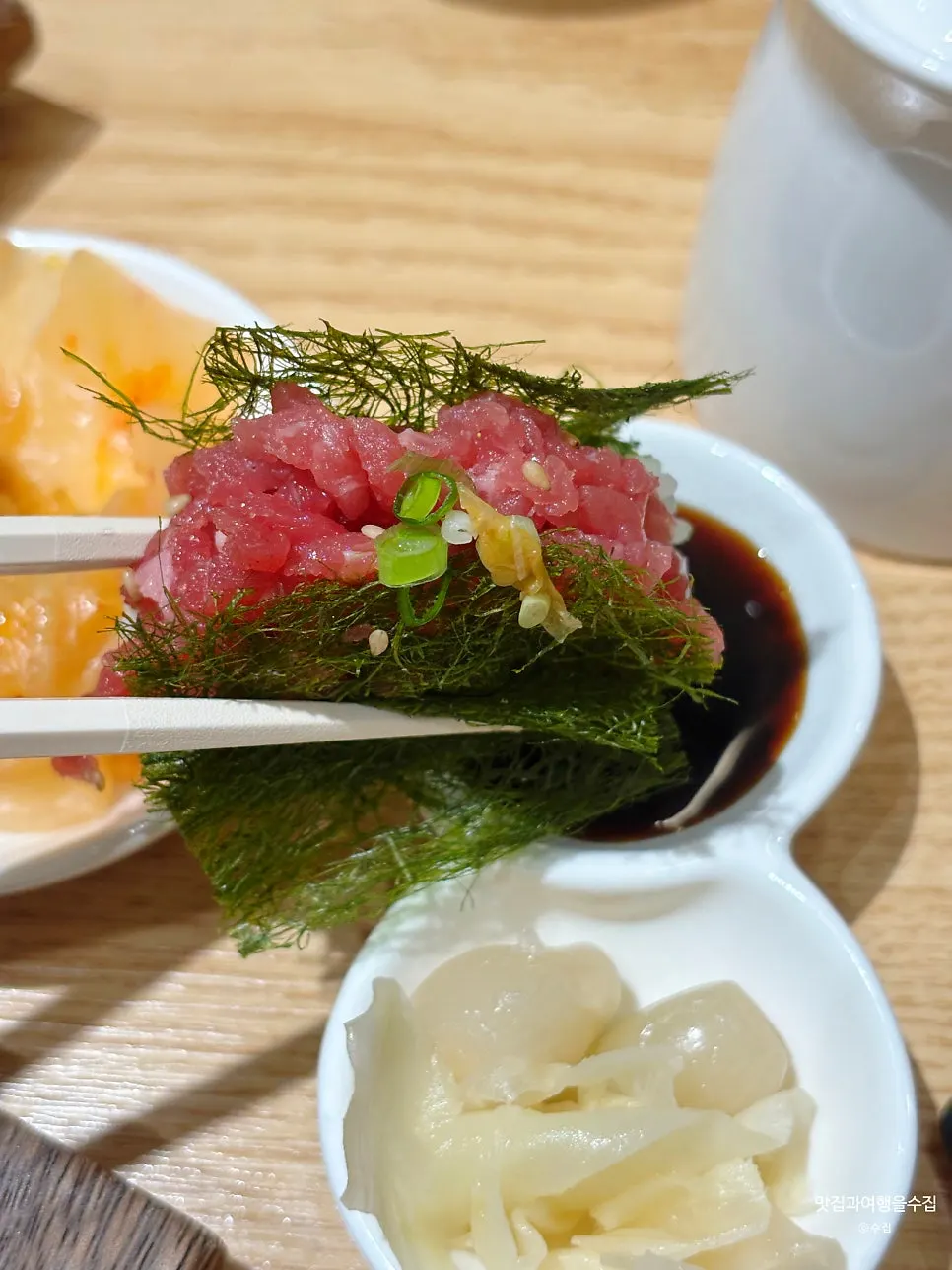 A piece of beef tartare sushi wrapped in gimtae