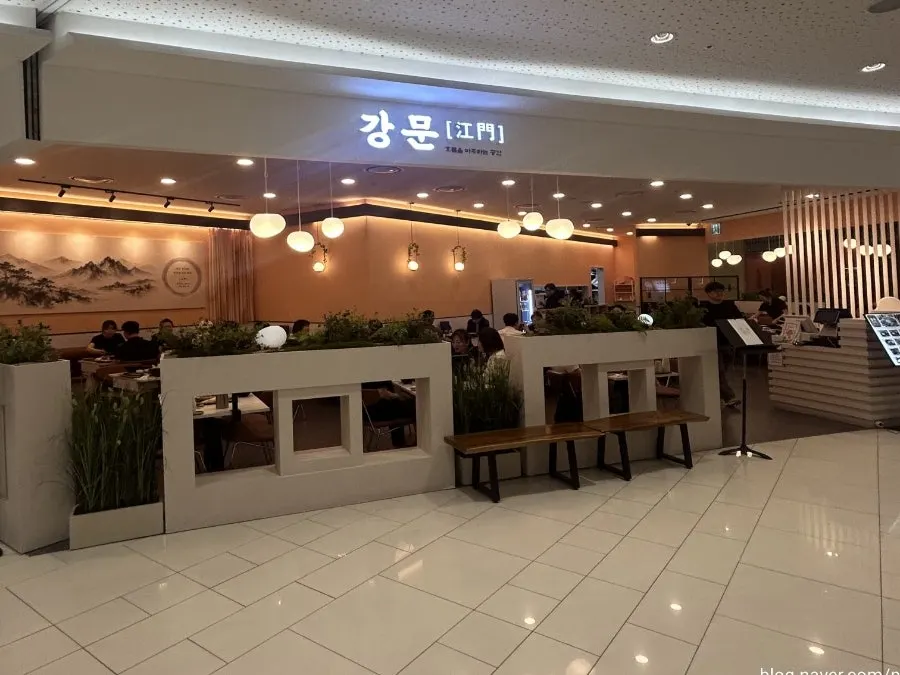 Interior of Gangmun Times Square Branch with beige wood tones and soft lighting