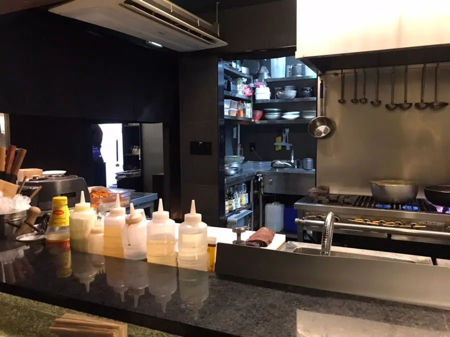 Open kitchen view from the bar table
