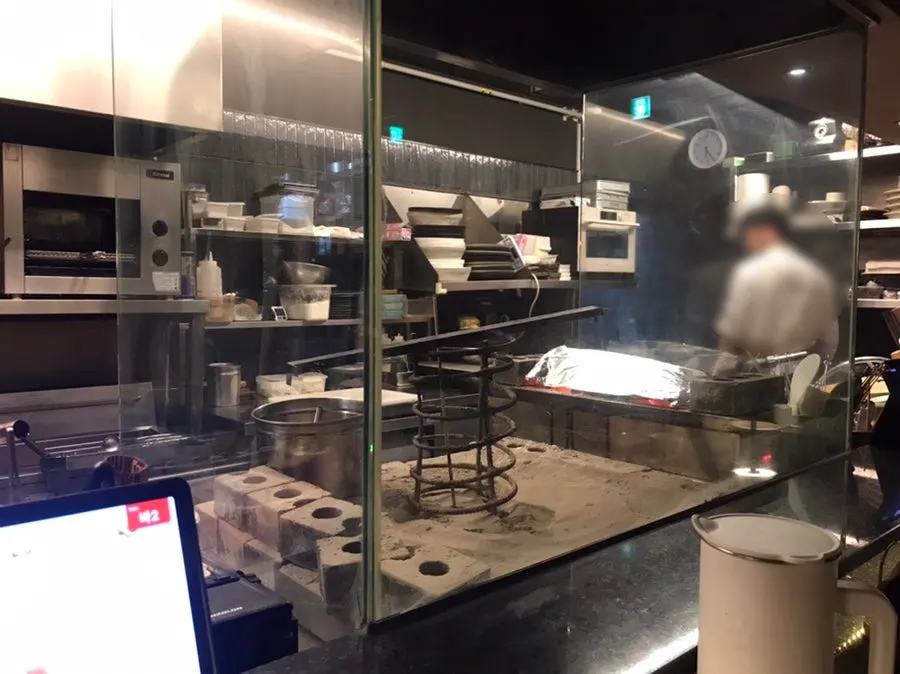 Fish grilling over an open flame in the kitchen