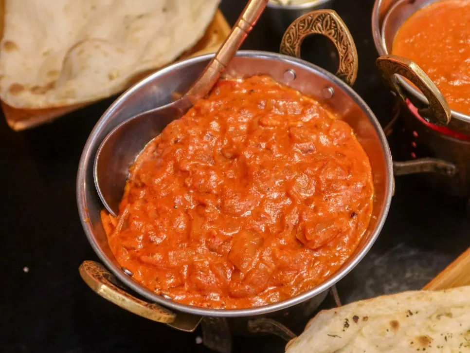 Dipping naan into curry