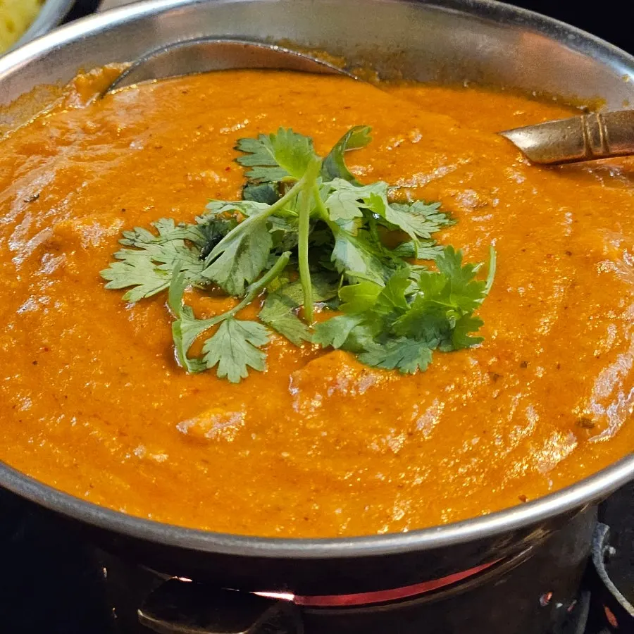 Butter chicken curry topped with cilantro