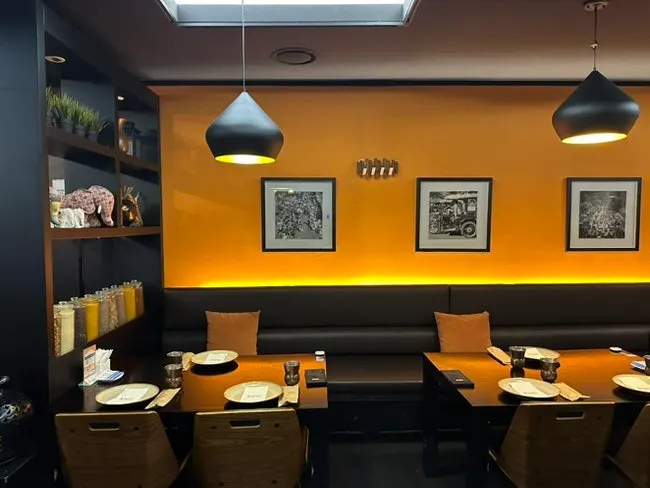 Kari's main hall interior in monotone with tangerine accents