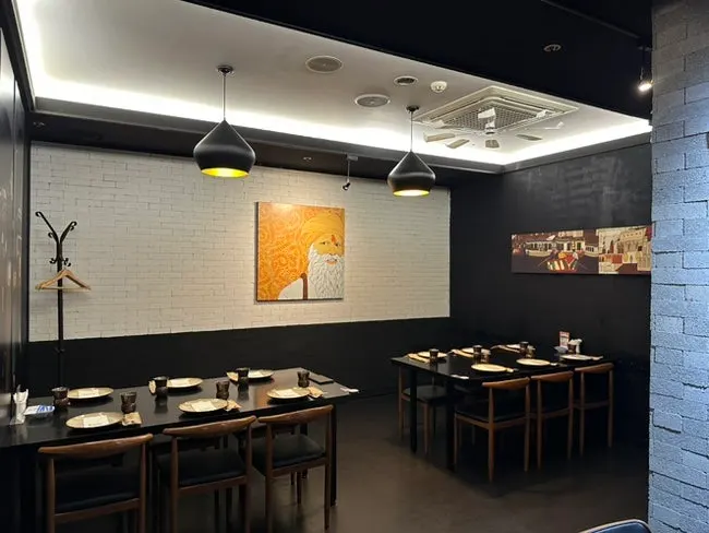 Calmly lit dining table setting at Kari