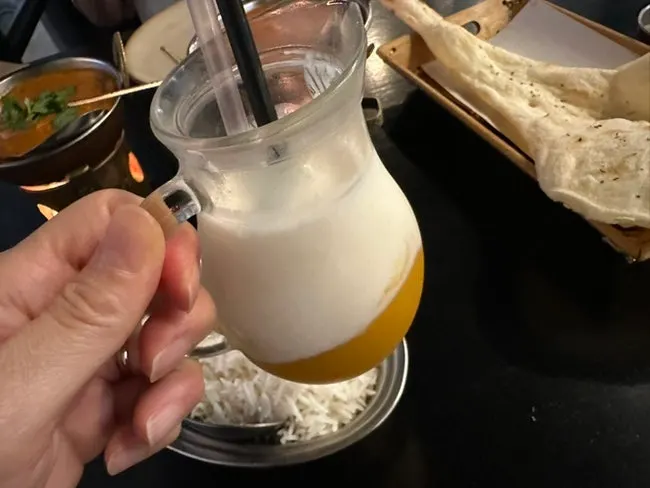 Mango lassi generously topped with mango purée