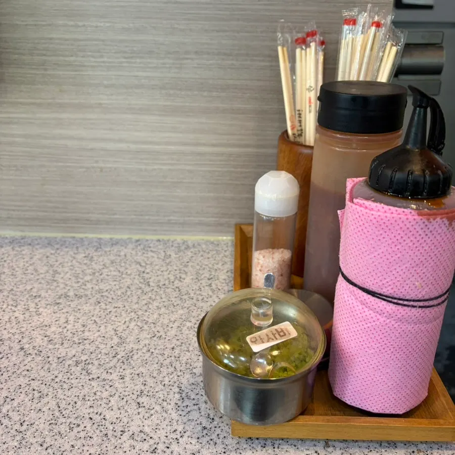 Salt, wasabi, and tonkatsu sauce set at the table