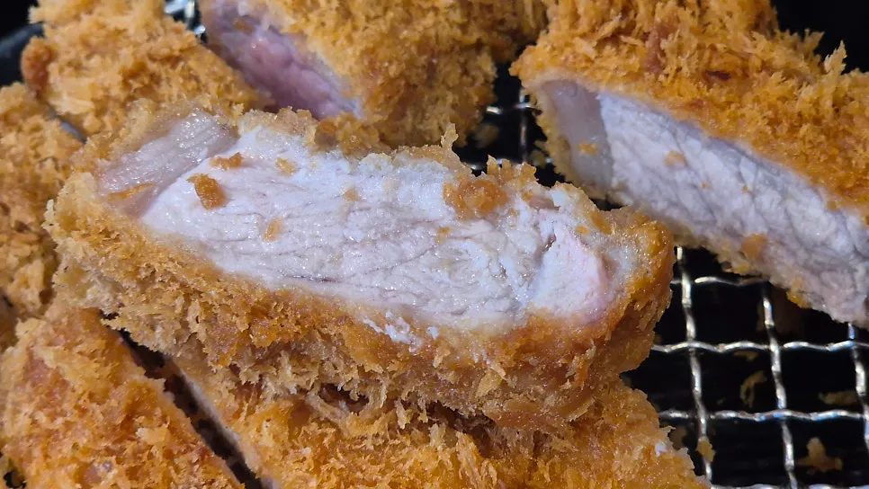 Dipping tonkatsu into the thick curry