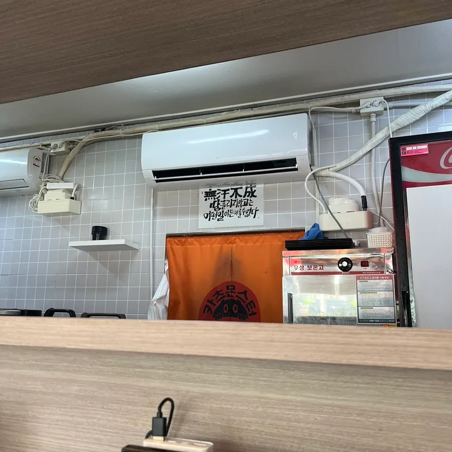 Open kitchen with a sign hanging above it