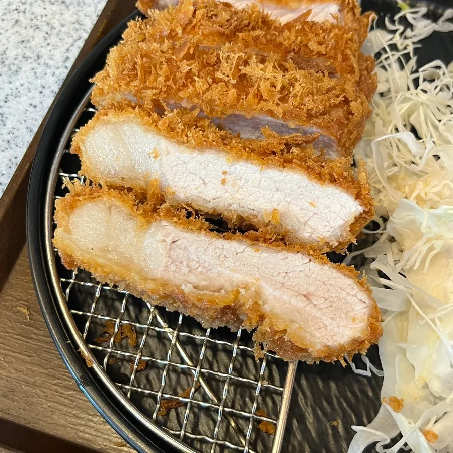 A piece of loin katsu showing its cross-section