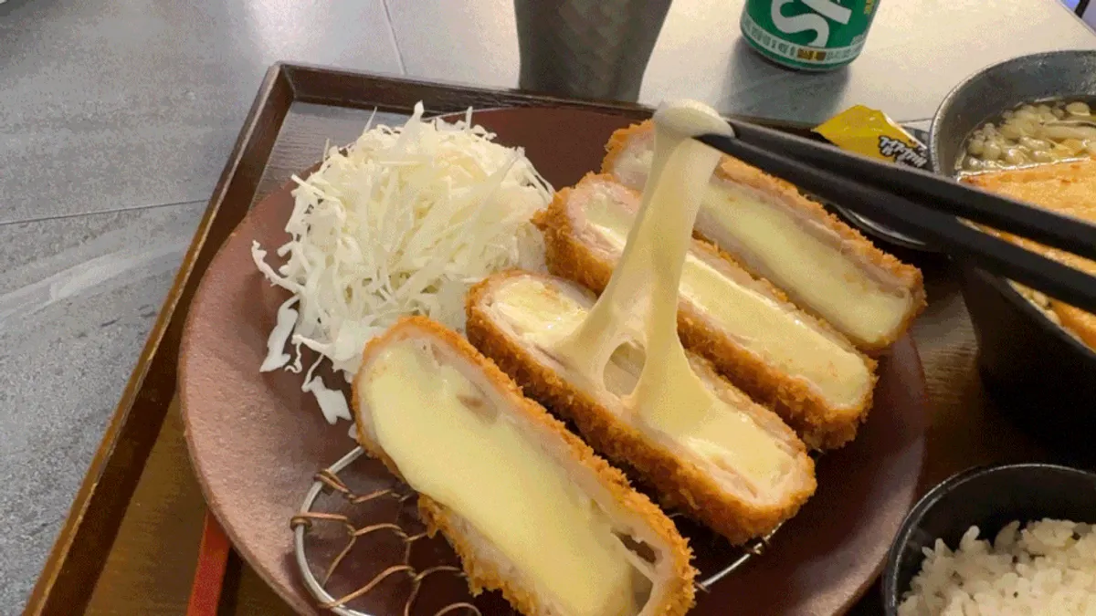 Cross-section of cheese katsu with mozzarella stretching out
