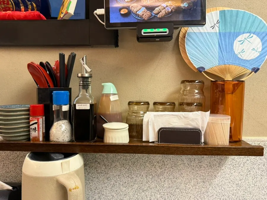 Various sauces and cups set out at the table