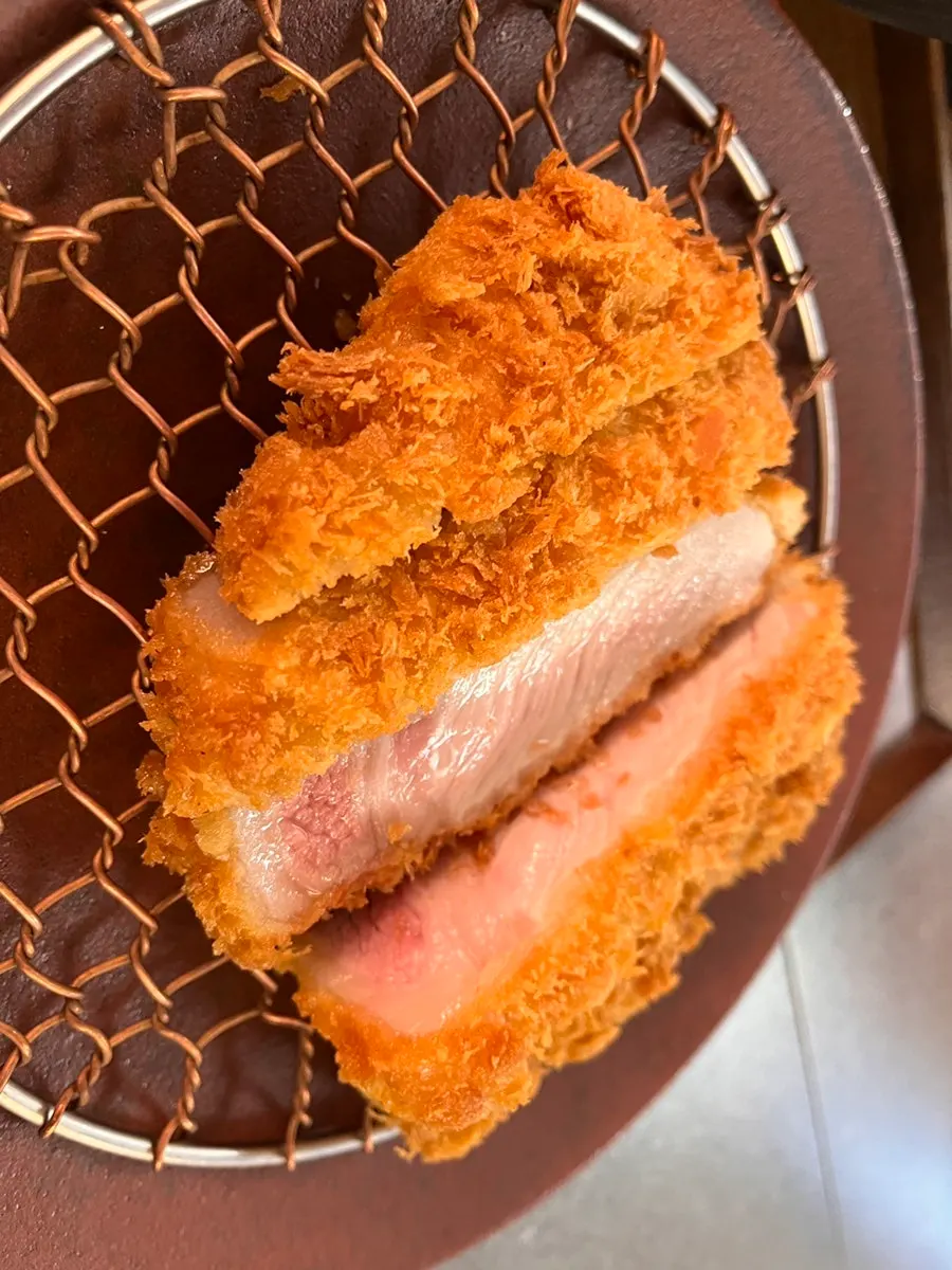 Picking up a piece of rosukatsu