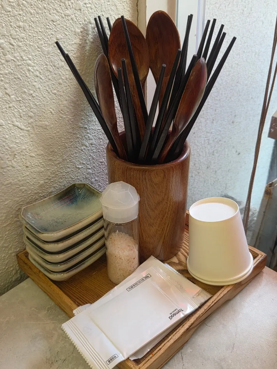 Water and tonkatsu sauce set on the table after ordering
