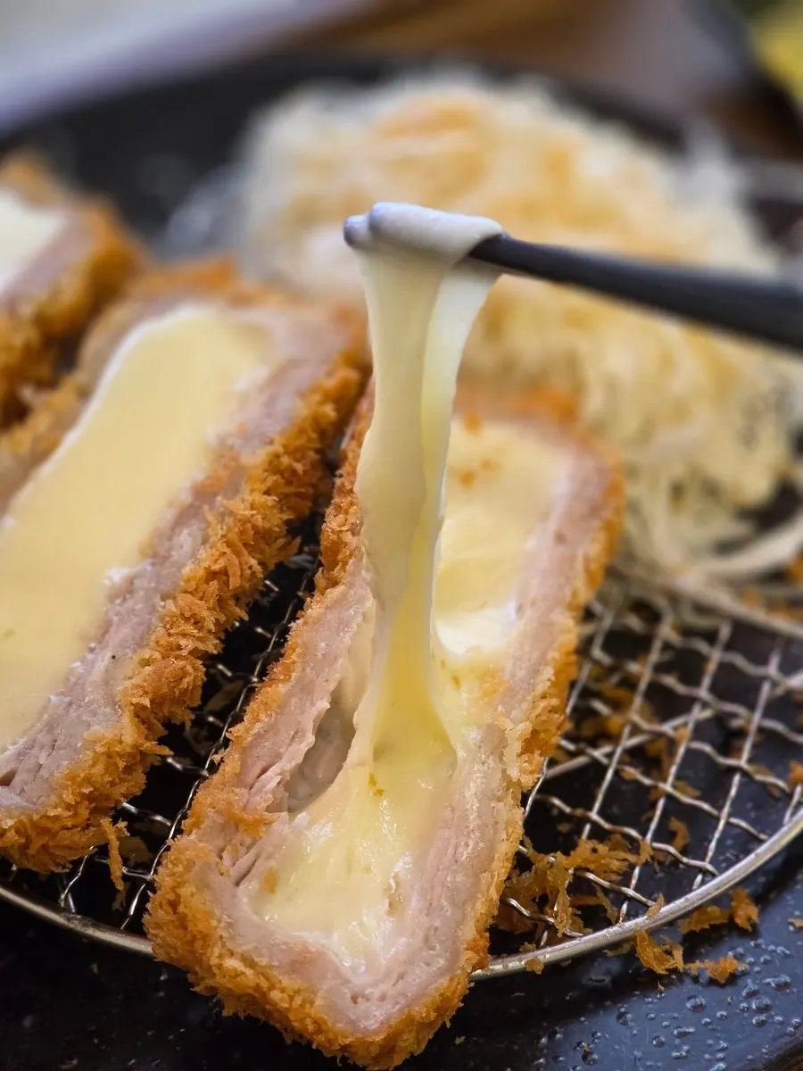 Cross-section of cheese katsu with stretchy melted cheese