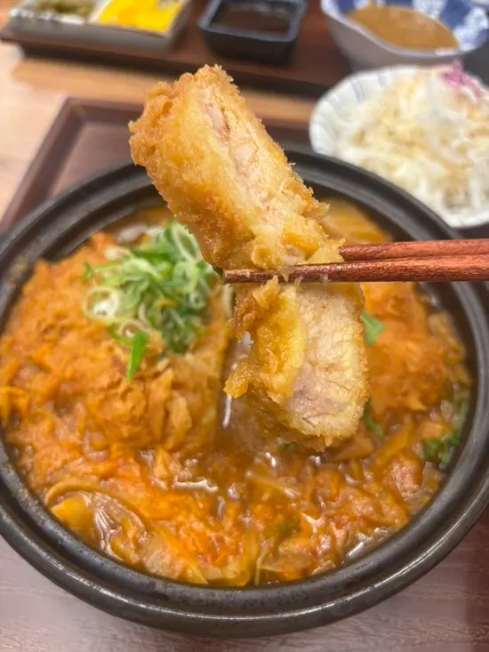 Thick slice of katsu on top of kimchi broth