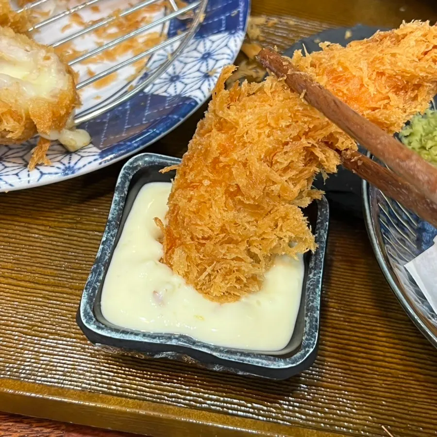 Fried shrimp dipped in tartar sauce