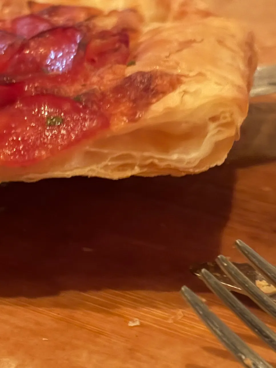 Pizza served with parmesan cheese, pickles, and Tabasco sauce