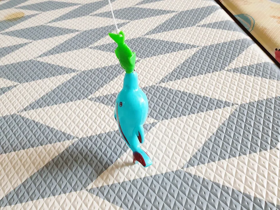 Playing with a magnetic fishing rod toddler toy