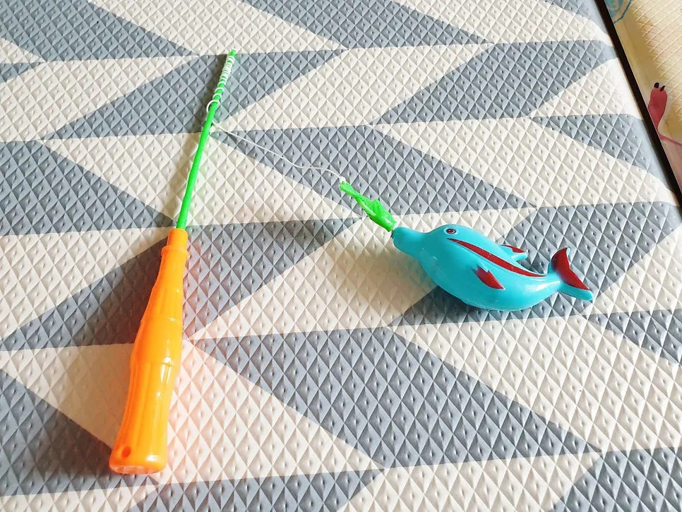 Child playing the magnetic fishing game