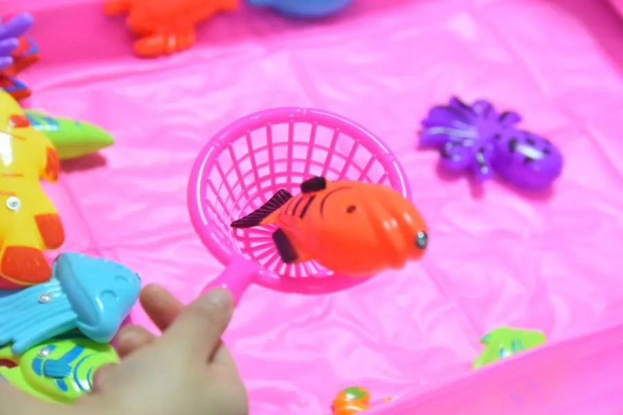 Sisters happily enjoying a fishing game together