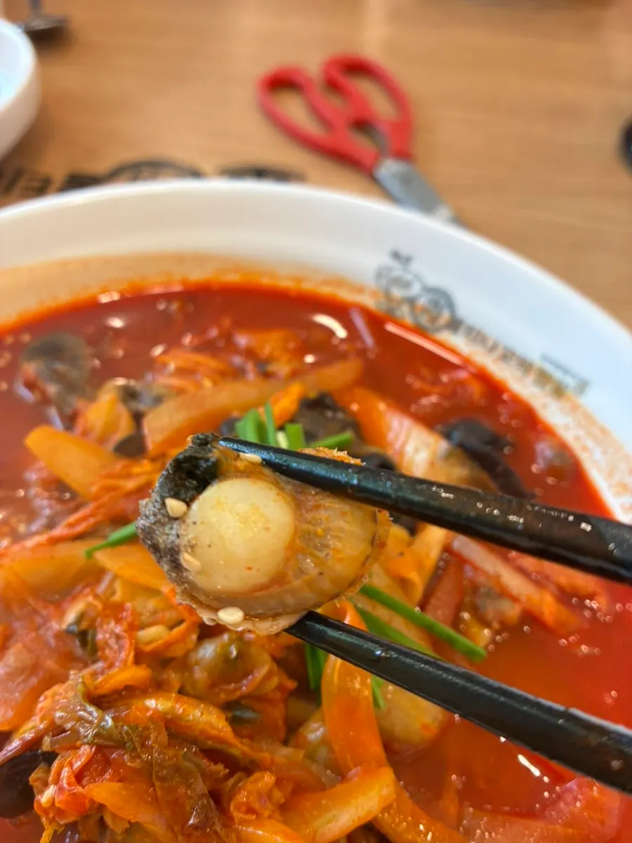 Bright red cockle jjamppong loaded with clams