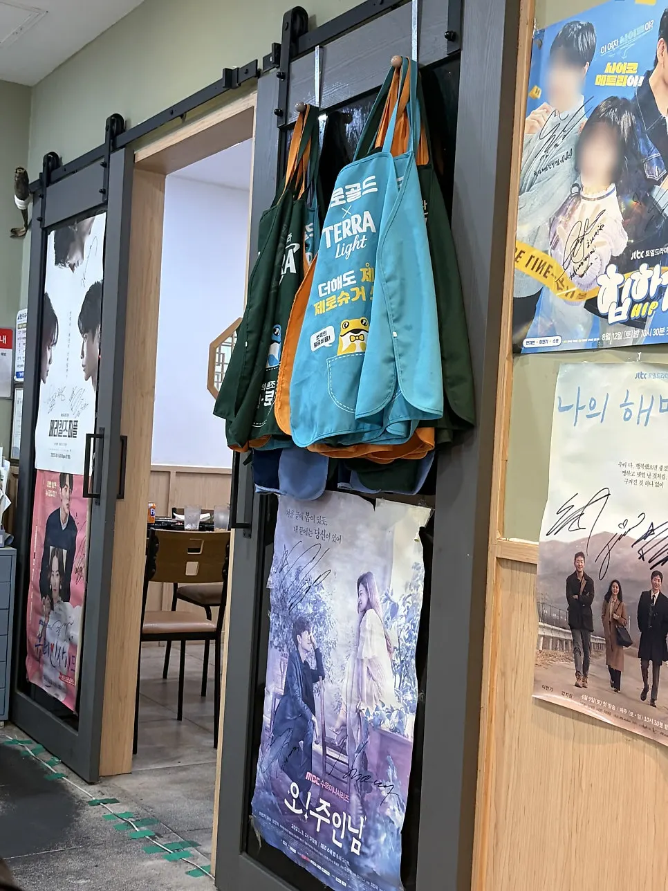 Interior with drama posters and celebrity autographs