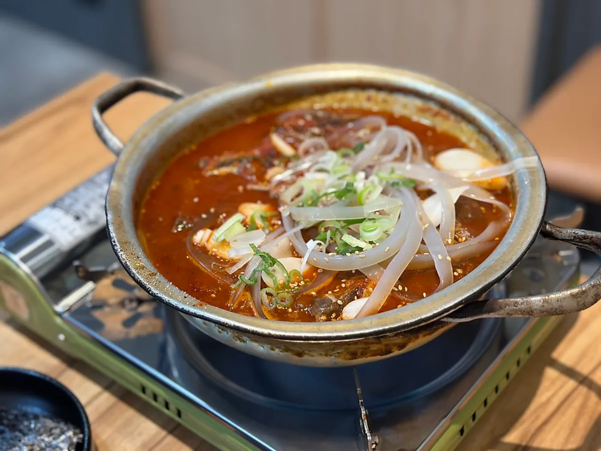 Beef spicy galbijjim for two served in a tin pot